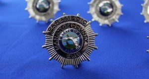 The photo shows a close up of a Manatee County EMS badge.