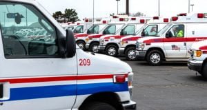 Rows of ambulances are parked outside.