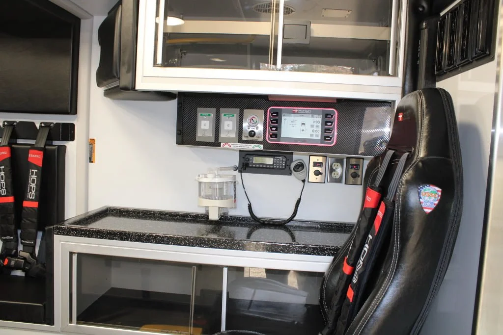 The Black Sierra USSC high-back bucket attendant's seat has an integral child safety seat and is protected by a Per4max four-point harness.