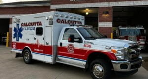 The Calcutta Fire Department's new ambulance sits in front a garage bays.