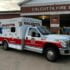 The Calcutta Fire Department's new ambulance sits in front a garage bays.