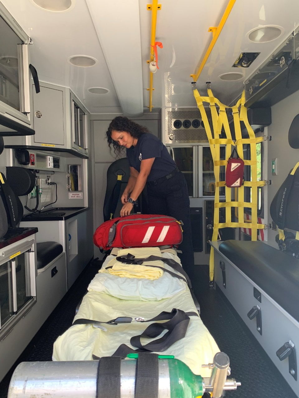 Mill Creek firefighter/EMT Argelis Arauz restocks the new Wheeled Coach Type 3 ambulance.