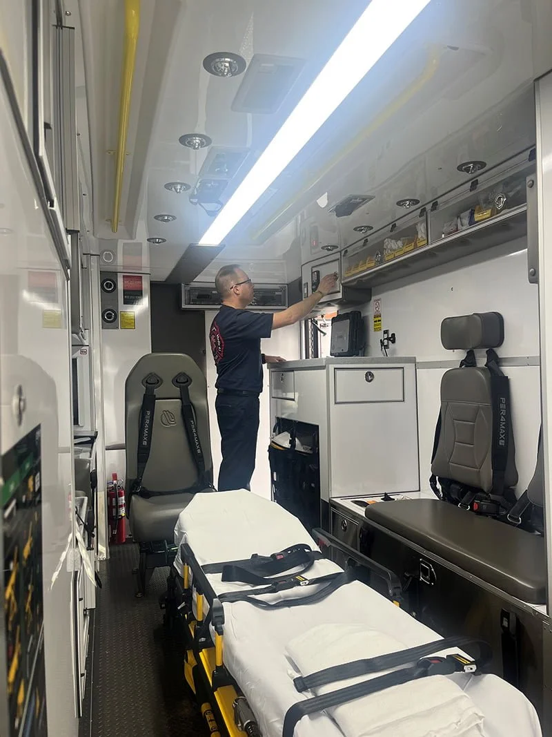 A Collinsville firefighter/paramedic restocks a cabinet in the new Traumahawk.