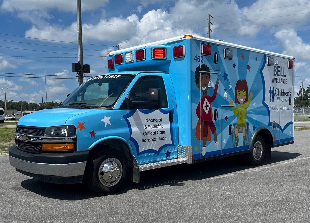A blue ambulance with graphics of kids.