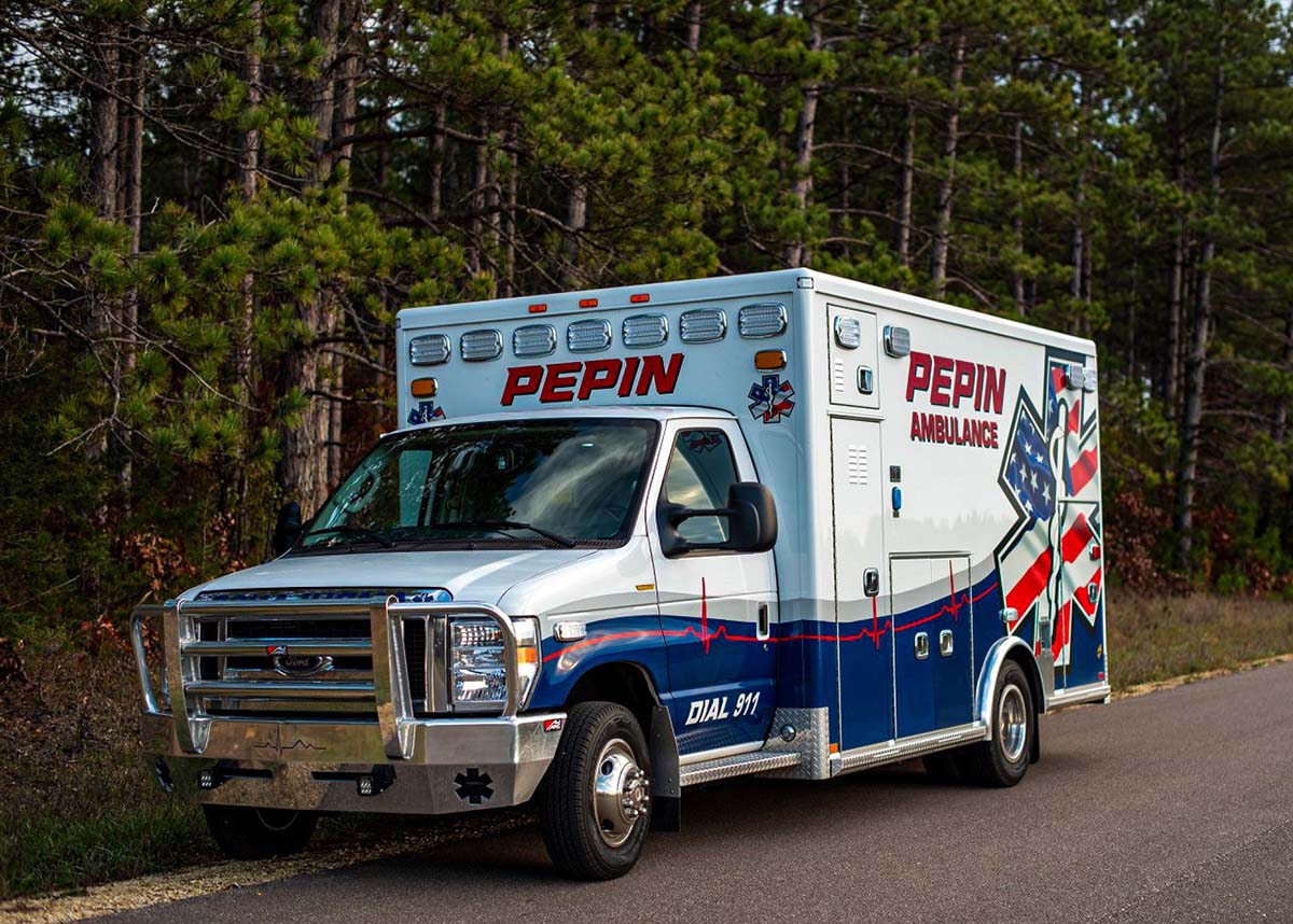 A photo of the new ambulance parked on the road.