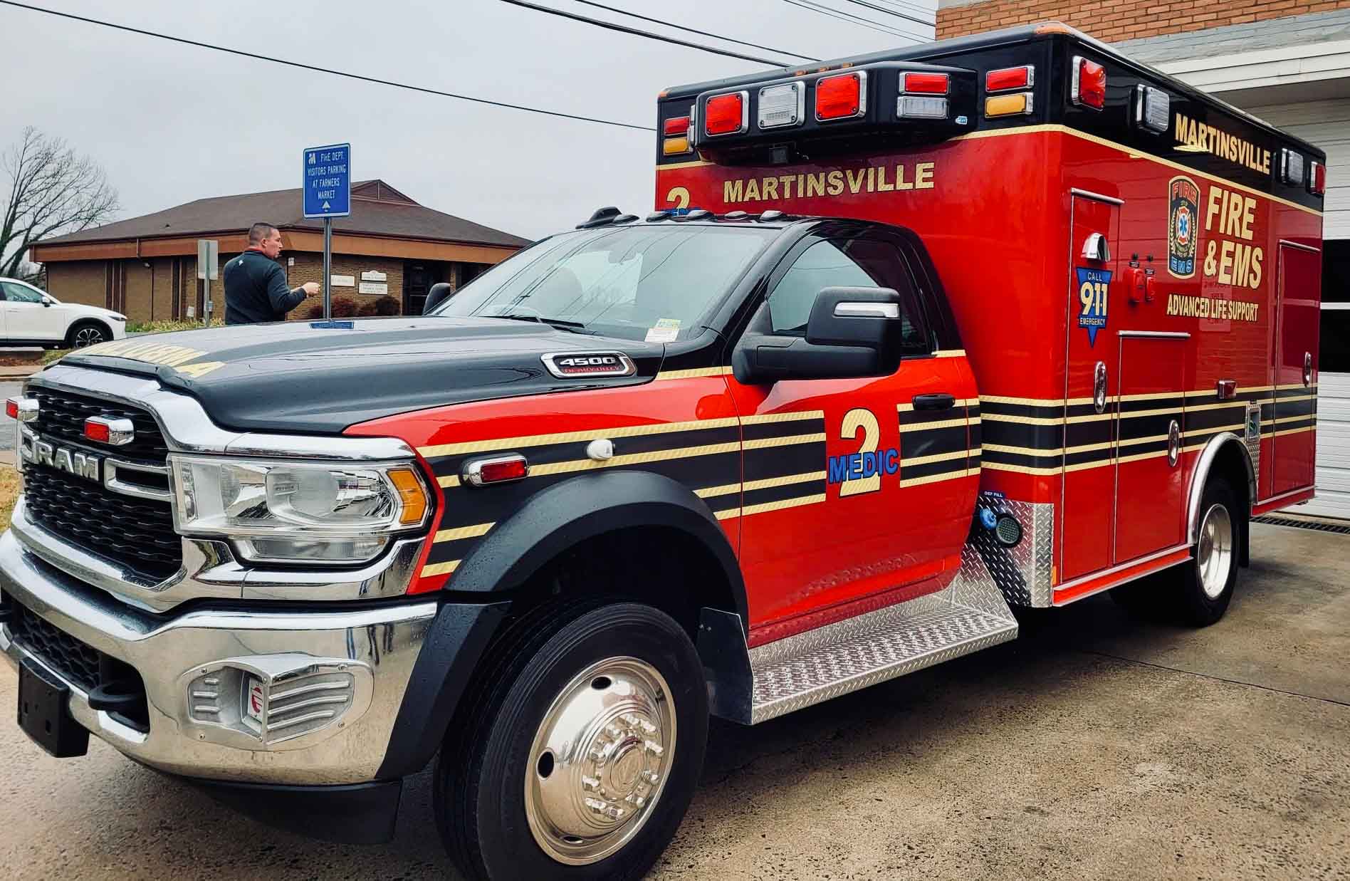 A picture of a red ambulance outside.